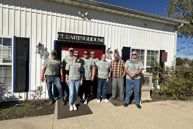 Jackson County REMC employees pose after a day of work at Scott County Clearinghouse, a food pantry in Scottsburg.